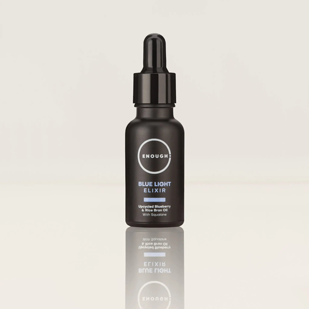 Black bottle of 'Enough' Blue Light Elixir on a light gray background