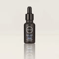 Black bottle of 'Enough' Blue Light Elixir on a light gray background