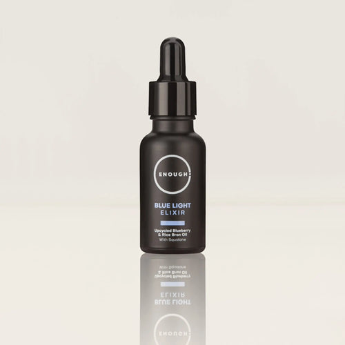 Black bottle of 'Enough' Blue Light Elixir on a light gray background