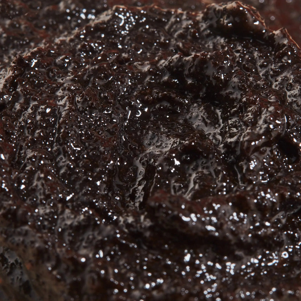 Close-up of ENOUGH caffeine and essential oil body scrub