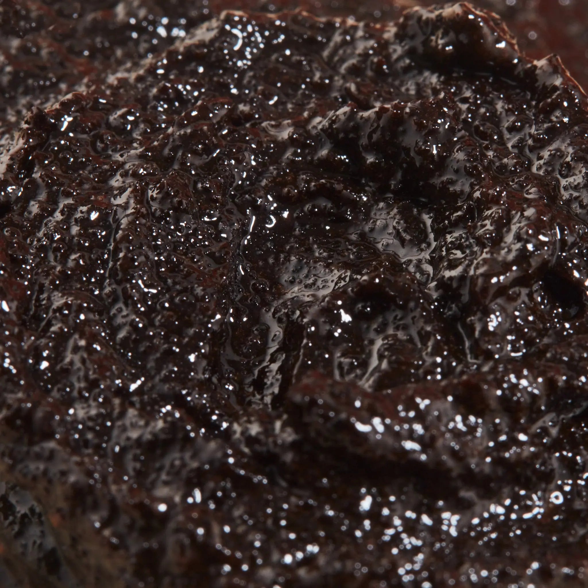 Close-up of ENOUGH caffeine and essential oil body scrub
