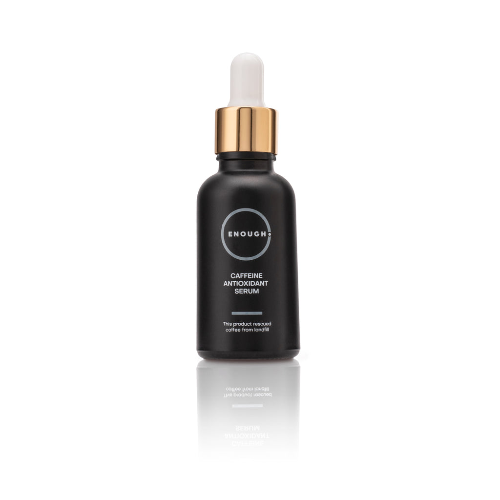 Black serum bottle with gold cap containing Caffeine Antioxidant serum on a white background