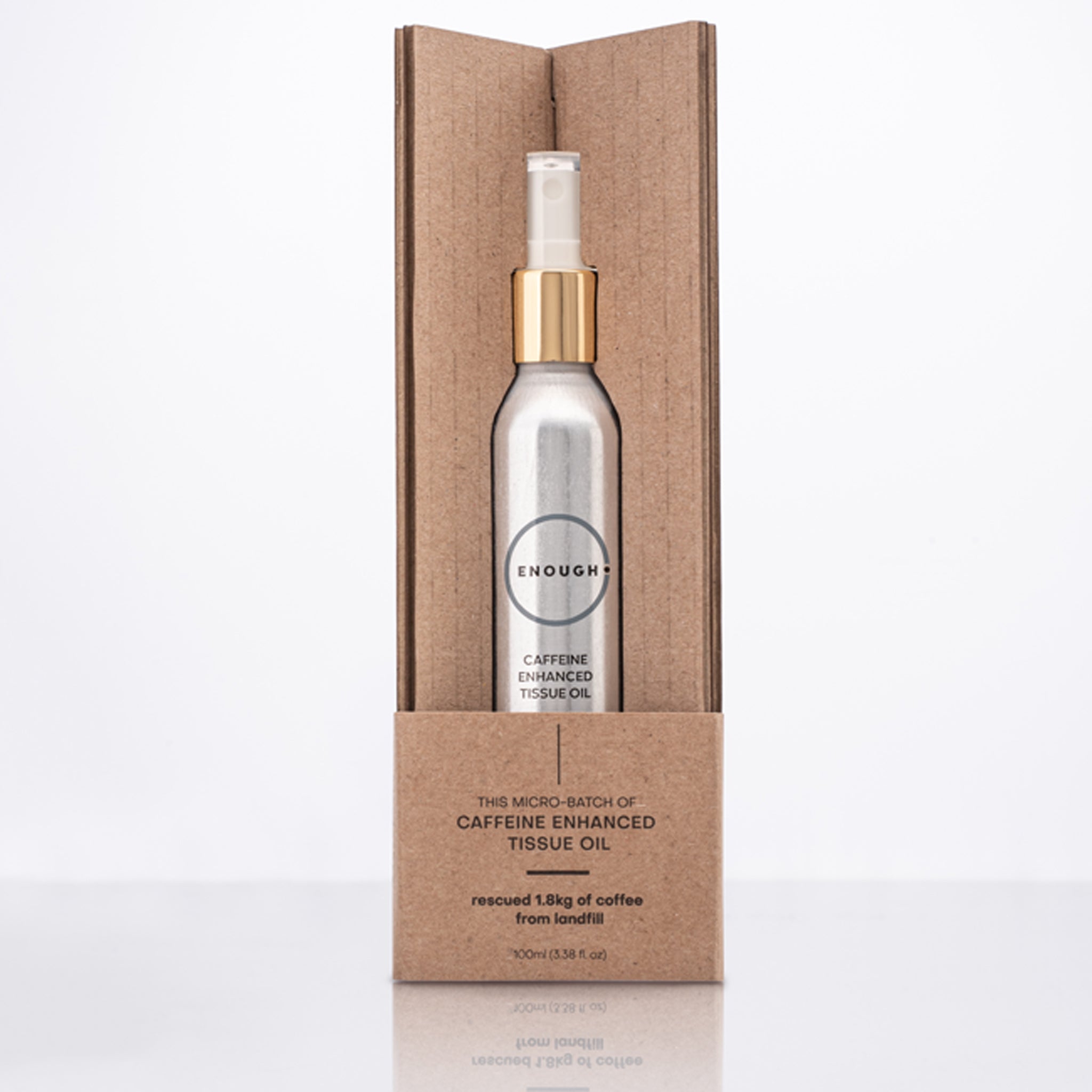 Spray bottle containing Caffeine Enhanced Tissues Oil in a cardboard packaging on a white background