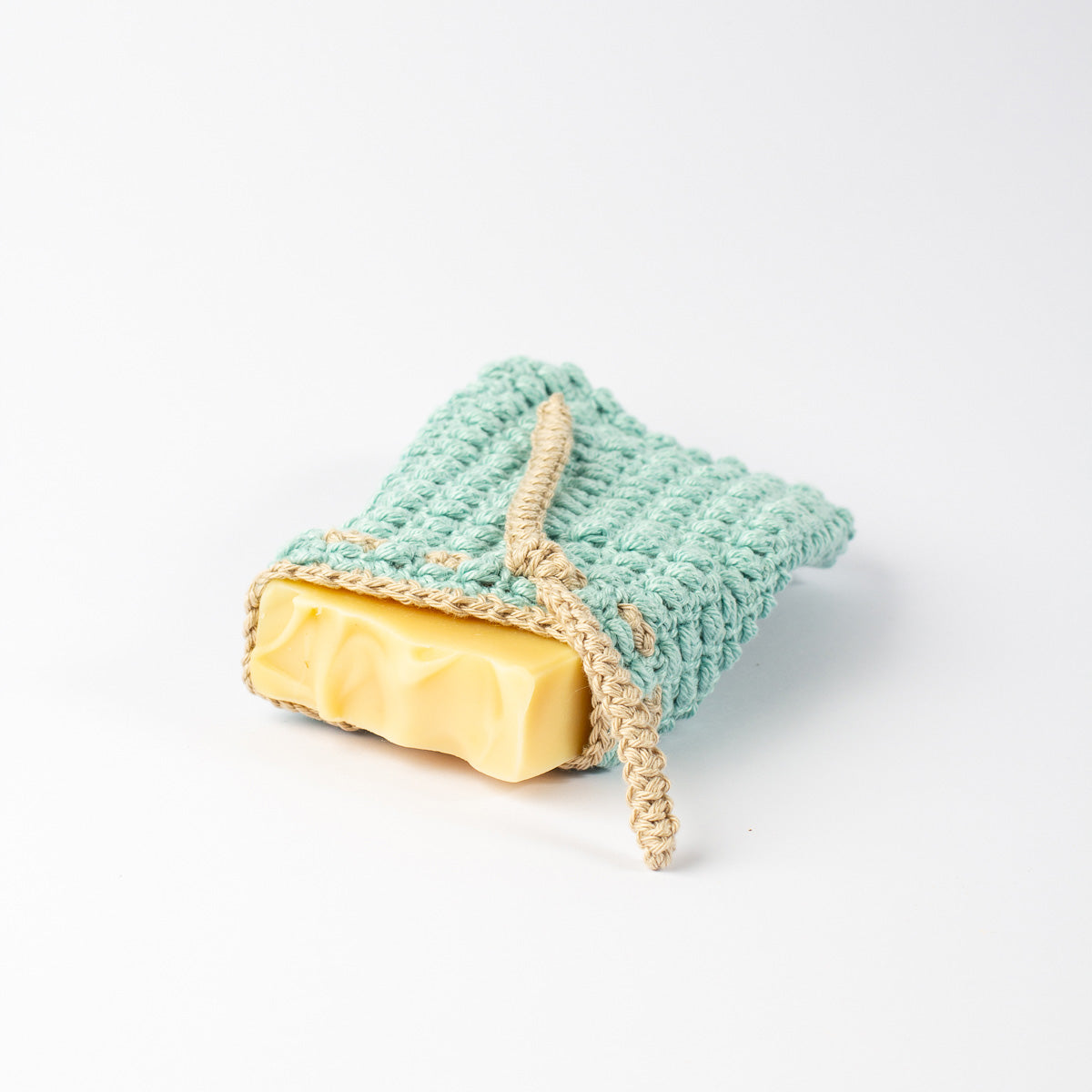 ECONIQUE natural cotton soap saver bag in use with bar soap inserted